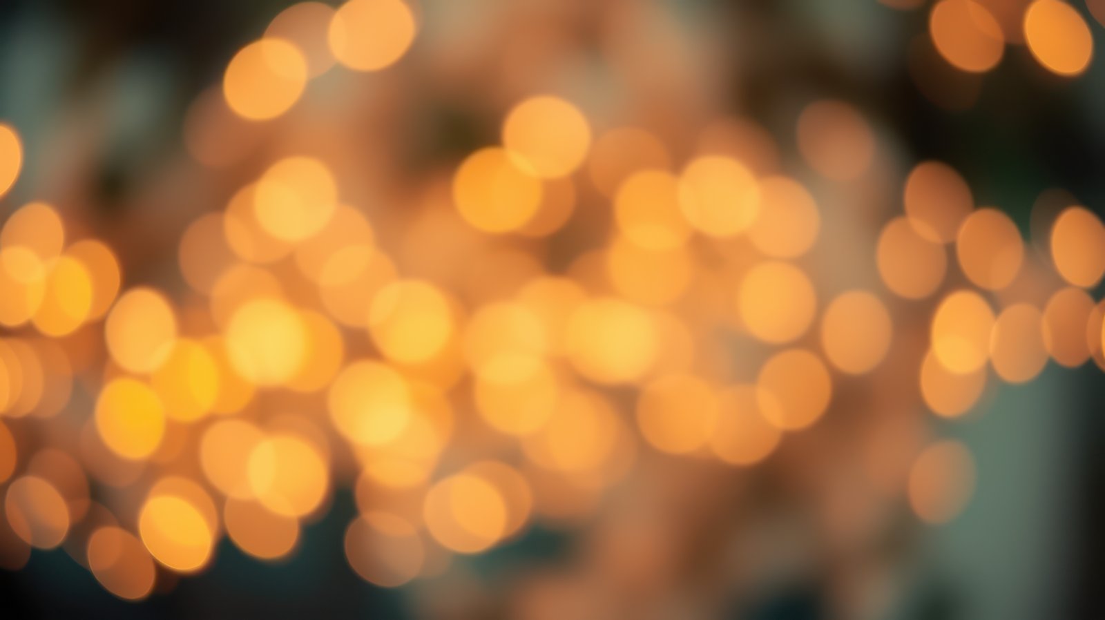 Bright bokeh lights create a warm atmosphere in a cozy indoor setting during an evening gathering
